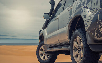 A powerful gray 4x4 SUV stands alone in the vast sandy terrain of the Namib Desert, ready for off-road travel, exploration, and endurance across one of Africa’s wildest landscapes. 