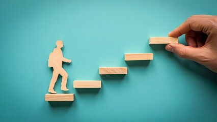 Person climbing steps constructed by a hand represents achieving goals and climbing the career ladder with determination