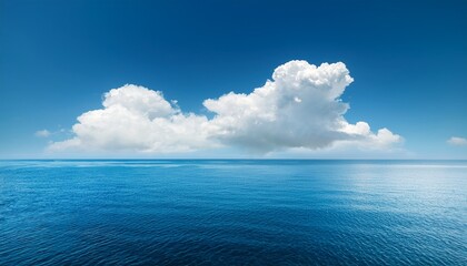 Obraz premium fluffy white cloud floating peacefully over blue ocean water serene nature scene