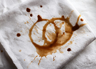 Coffee, chocolate, liquid stains isolated on a white fabric background. Royalty high-quality free stock photo image of Coffee, tea stains spill. Round coffee stain isolated, cafe splash fleck drink