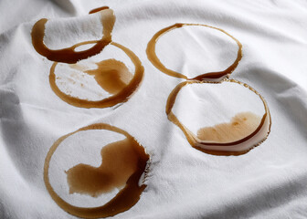 Coffee, chocolate, liquid stains isolated on a white fabric background. Royalty high-quality free stock photo image of Coffee, tea stains spill. Round coffee stain isolated, cafe splash fleck drink