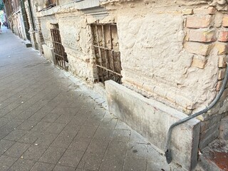 Old urban brick building facade. Building plinth wall.