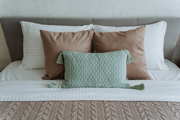 There is a cozy bed that features a warm blanket neatly spread over it, along with soft pillows...
