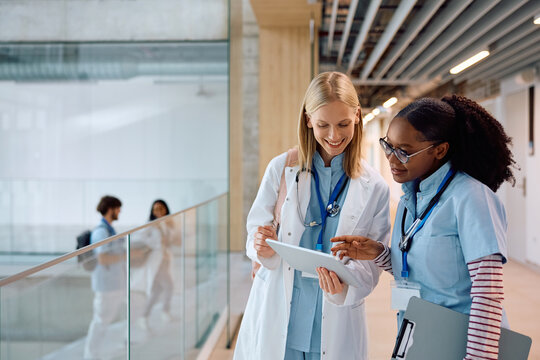 Happy female medical student using digital tablet at university.
