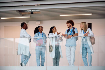 Happy medical and nursing students talking after lecture at university.