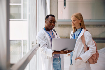 Medical students surfing the net on laptop at university.