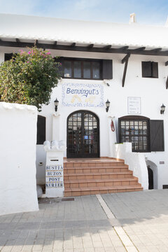 White building and cozy shop with stairs in Menorca, Spain