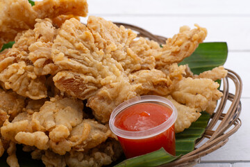 Close up crispy fried mushrooms with spicy tomato sauce Indonesian street food