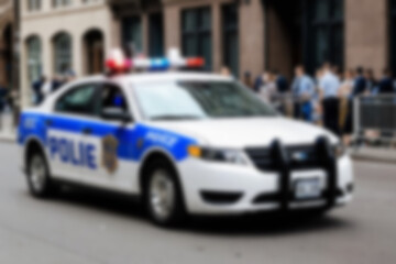 Blurry photo of a police car patrolling the busy city center.