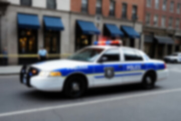 Blurry photo of a police car patrolling the busy city center.