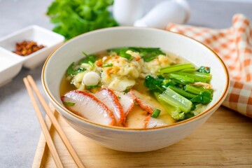 Wonton with bbq Pork Soup in a ceramic bowl	