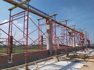 Workers are installing reinforcement on the scaffolding