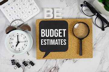 BE - Budget Estimates acronym with alarm clock and magnifying glass, Financial concept background