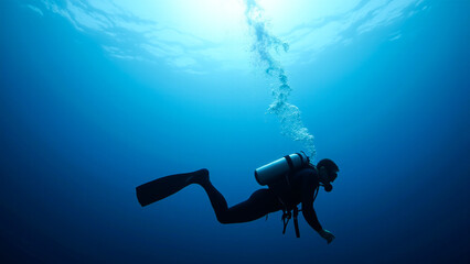 scuba diver swimming in the ocean, wearing a swimsuit and an oxygen cylinder on their back