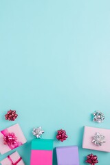 Celebratory gifts and ribbons on turquoise