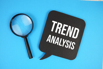 Trend Analysis text with magnifying glass on blue background