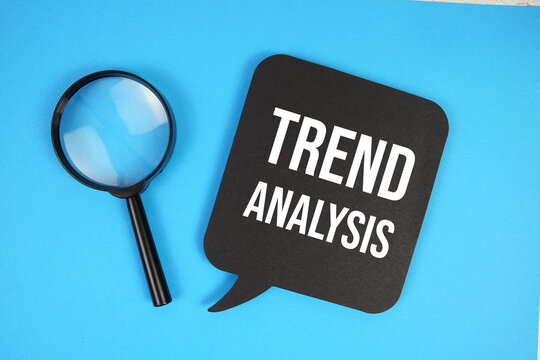 Trend Analysis text with magnifying glass on blue background