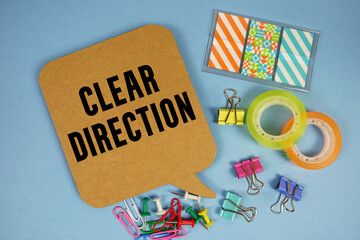 Clear Direction text with stationery on blue background