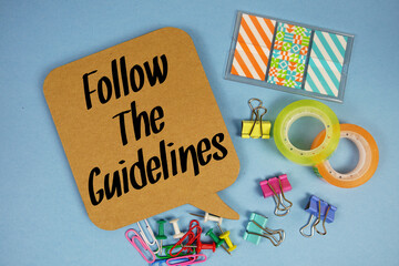 Follow The Guidelines text with stationery on blue background