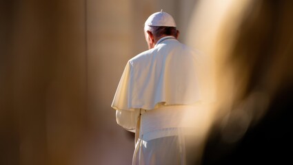 Elderly caucasian male religious figure in white attire outdoors