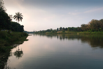 Tranquil Scenic View of a River Lined With Lush Green Trees