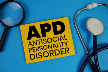 Antisocial Personality Disorder (APD)  text with Stethoscope and magnifying glass on blue background