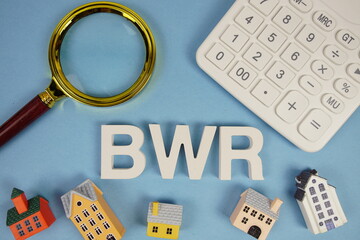 BWR abbreviation of Benefit Wage Ratio alphabet letters with house model, magnifying glass and...
