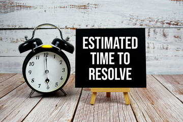 Estimated Time To Resolve text with easel and alarm clock on wooden background