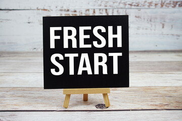 Fresh Start text with easel on wooden background