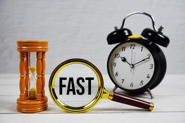 FAST abbreviation of Fast Arms Speech Time text with alarm clock on wooden background