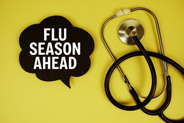 Flu Season Ahead text on speech bubble with stethoscope on yellow background, Healthy concept