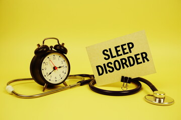 Sleep Disorder text on speech bubble with alarm clock and stethoscope on yellow background, Healthy...