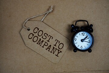 CTC Cost To Company text on price tag with alarm clock on cork board background