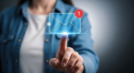 Digital Notification: A person's finger points toward a glowing digital envelope, indicating a new message, against a blurred backdrop suggesting online communication and technological advancements.