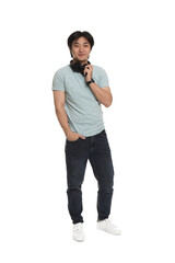 Handsome Asian man with headphones on white background