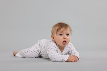 Cute little baby on light grey background