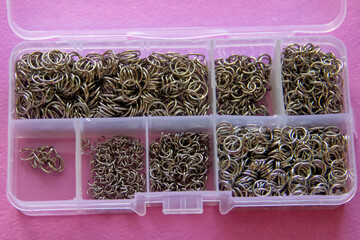 Furniture, beads for diy A clear box filled with various jewelrymaking components for crafting.