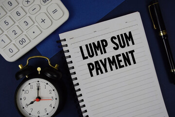 Lump Sum Payment text written on notepad with calculator and alarm clock on navy blue background
