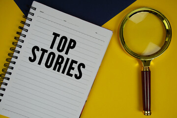 Top Stories text with magnifying glass on yellow background