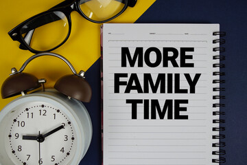 More Family Time text written on notepad with alarm clock on blue background