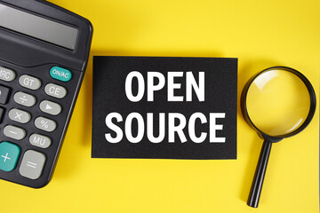 Open Source text with magnifying glass anc calculator on yellow background