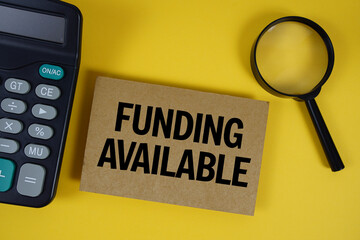 Funding Available text with magnifying glass anc calculator on yellow background