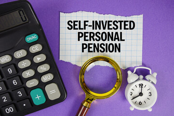 SIPP Paper with Self-Invested Personal Pension text with alarm clock, magnifying glass anc...
