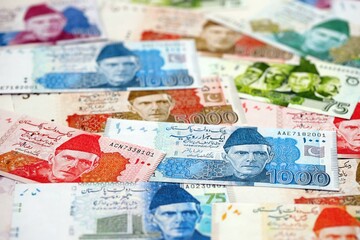 Pakistan rupees banknotes. The current Pakistan money bills lies on table in big amount