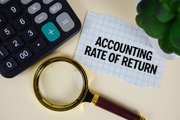 Accounting Rate Of Return text with magnifying glass anc calculator on yellow background