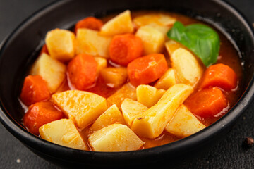 Stewed potatoes with carrots vegetarian side dish fresh delicious gourmet food background on the table rustic food top view copy space keto and paleo diet vegan food
