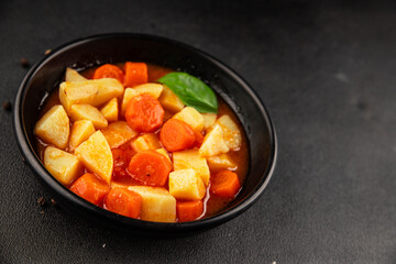 Stewed potatoes with carrots vegetarian side dish fresh delicious gourmet food background on the...
