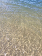 Crystal clear lake water reflecting the sun's rays and the surrounding nature creates a striking effect of transparency