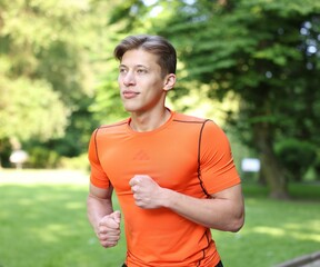 Sporty man running in park. Healthy lifestyle
