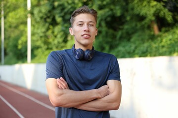 Portrait of sportsman with headphones at stadium